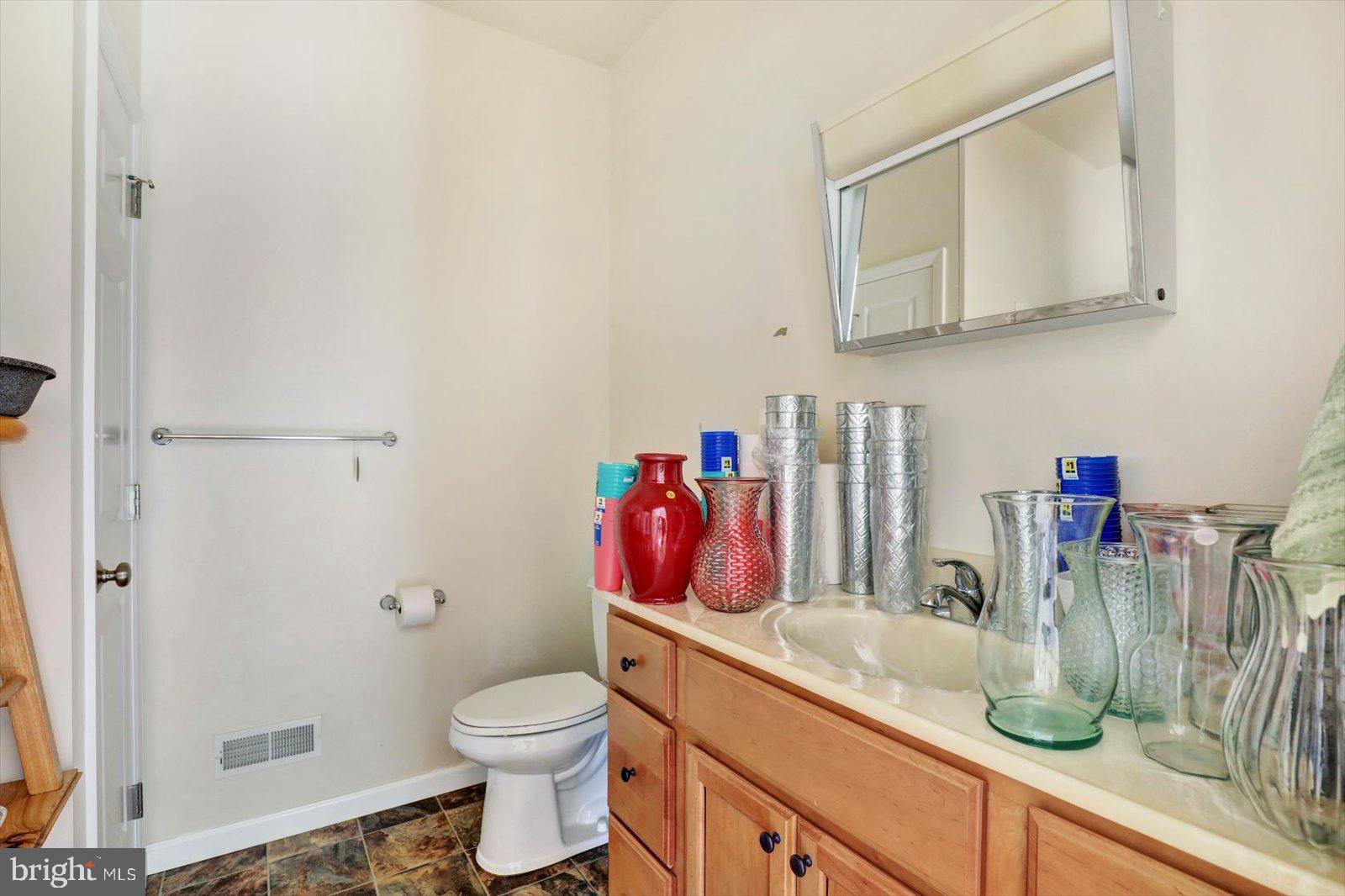 1881 Georgetown Road Christiana, PA 17509 - Photo 39 of 45 a bathroom with a granite countertop toilet sink and mirror