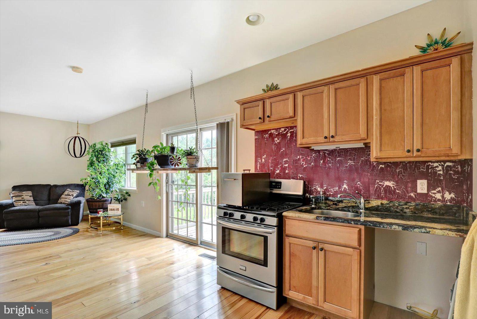 1881 Georgetown Road Christiana, PA 17509 - Photo 42 of 45 a kitchen with stainless steel appliances granite countertop a stove a sink and a refrigerator