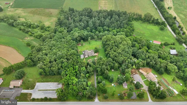 a view of a house with a yard and sitting area