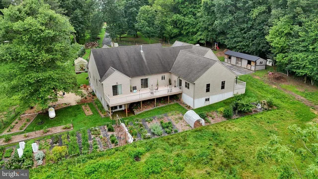 a aerial view of a house with a yard and sitting area