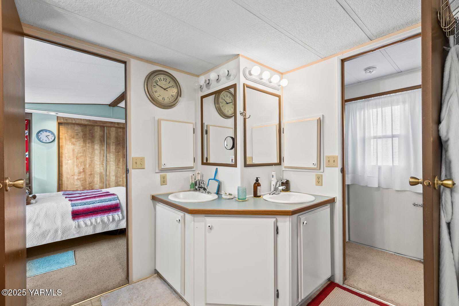 3601 Castlevale Road, Unit 14 Yakima, WA 98902 - Photo 13 of 24 a en suite bathroom with a sink and a mirror