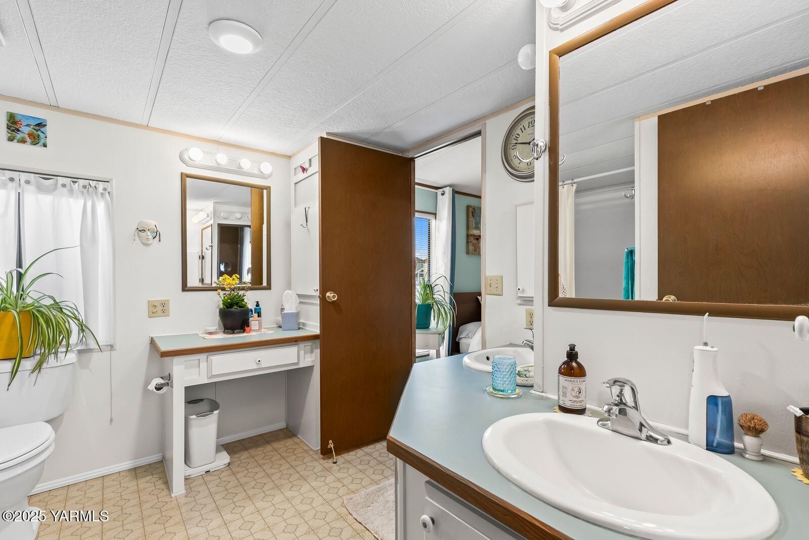 3601 Castlevale Road, Unit 14 Yakima, WA 98902 - Photo 15 of 24 a bathroom with a toilet sink and mirror