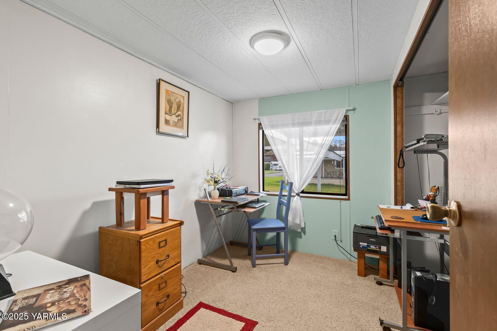 3601 Castlevale Road, Unit 14 Yakima, WA 98902 - Photo 16 of 24 a living room with furniture a window and a table