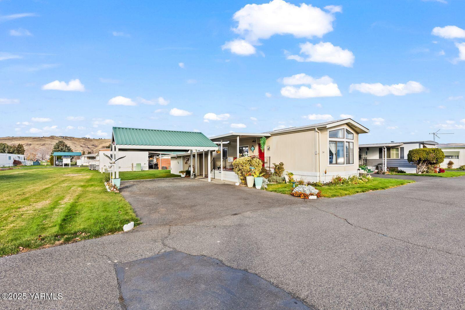 3601 Castlevale Road, Unit 14 Yakima, WA 98902 - Photo 3 of 24 a view of a house with a yard and garage