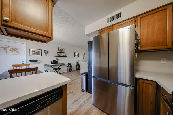a kitchen with stainless steel appliances a refrigerator and a stove top oven