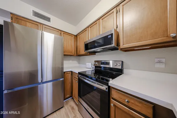 a kitchen with stainless steel appliances a refrigerator a stove and cabinets