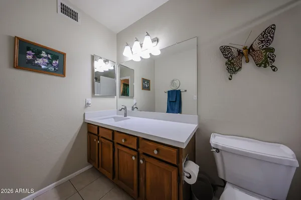 a bedroom with furniture and a flat screen tv