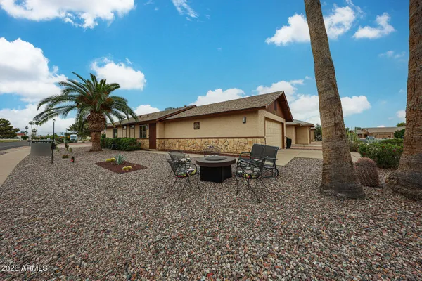 a front view of a house with yard and parking