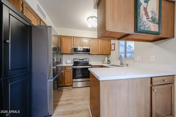 a kitchen with stainless steel appliances a sink and a refrigerator