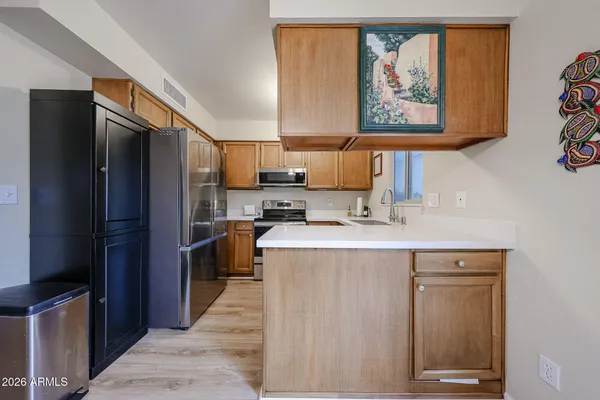 a kitchen with stainless steel appliances a refrigerator and a stove top oven