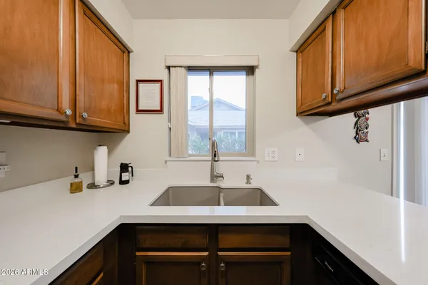 a kitchen with a sink cabinets and a window