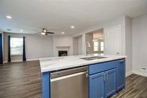 a kitchen with sink cabinets and wooden floor