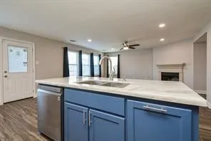 a kitchen with kitchen island a sink and wooden floor