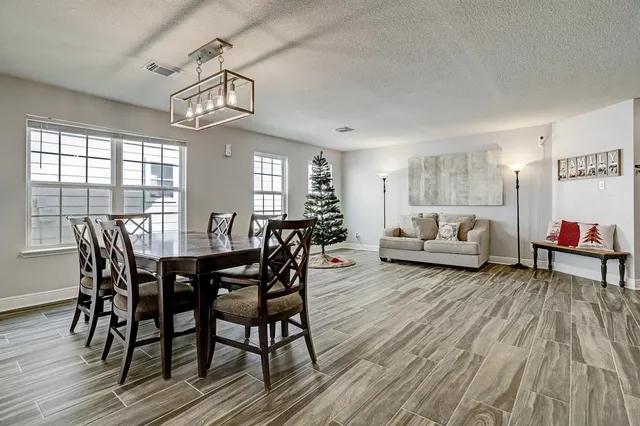 a view of a dining room with furniture window and wooden floor