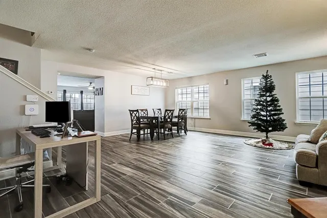 a workspace with furniture wooden floor and a window