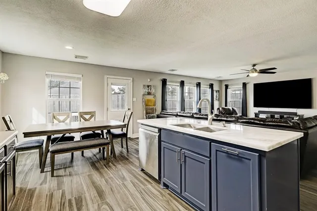 a large kitchen with a table and chairs in it