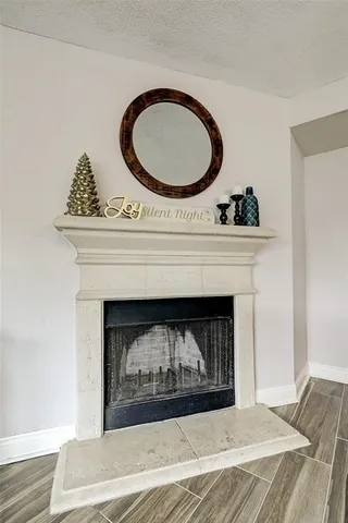a living room with a fireplace and a wooden floor