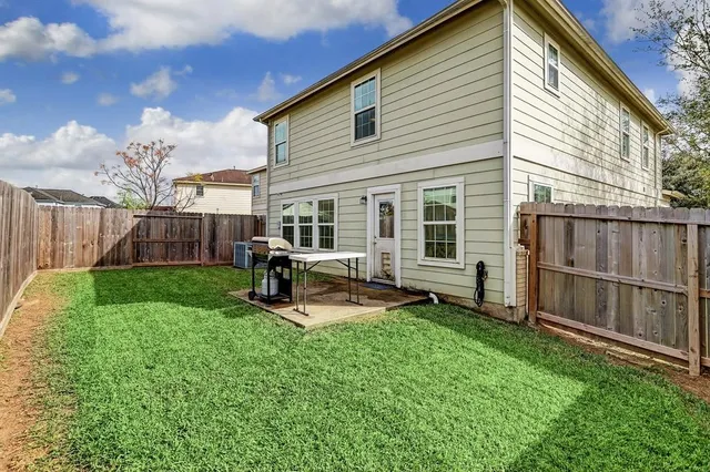 a view of a house with backyard and sitting area