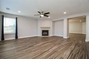a view of an empty room with a fireplace and a window
