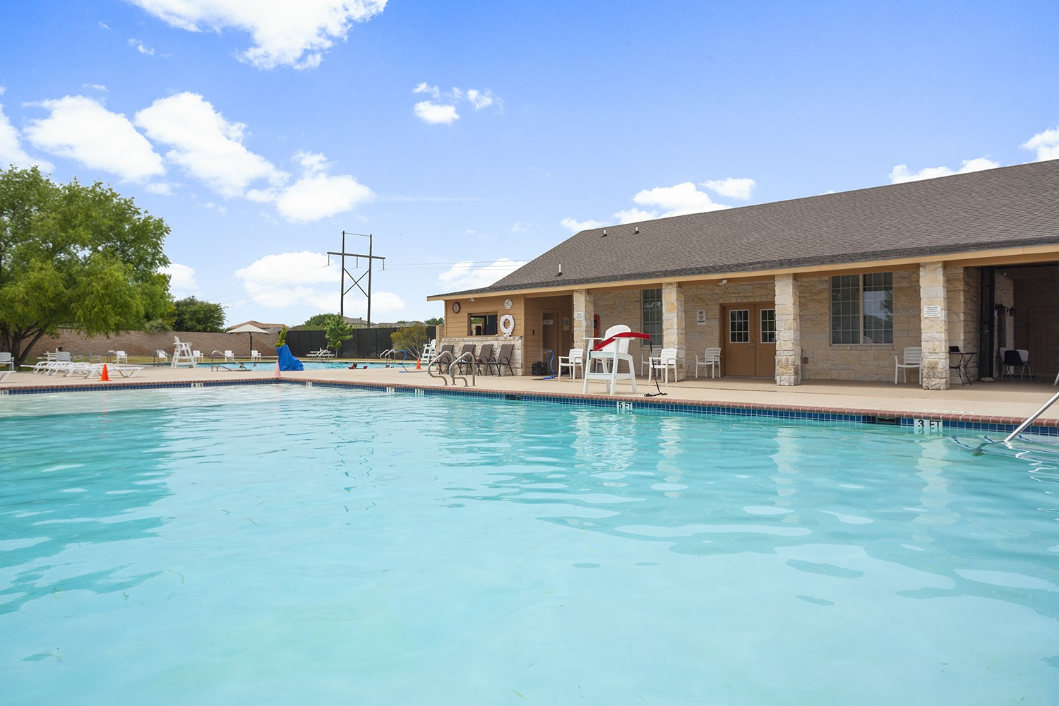257 Firefox Way Jarrell, TX 76537 - Photo 5 of 12 A sparkling community pool offers refreshing recreation beside a well-appointed clubhouse.