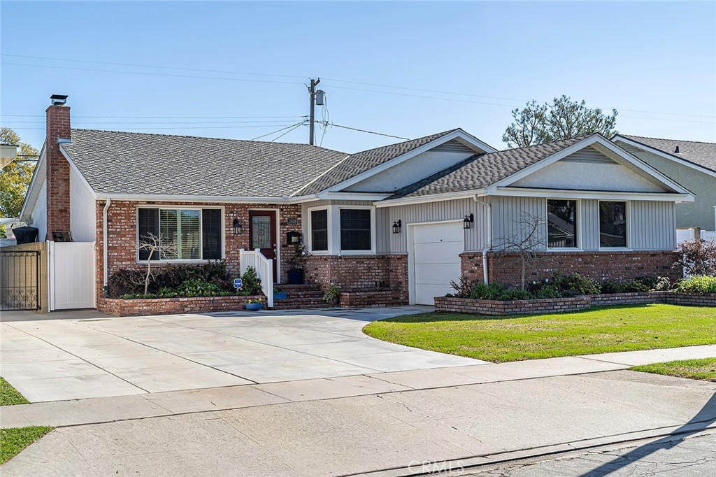 a front view of a house with swimming pool and yard