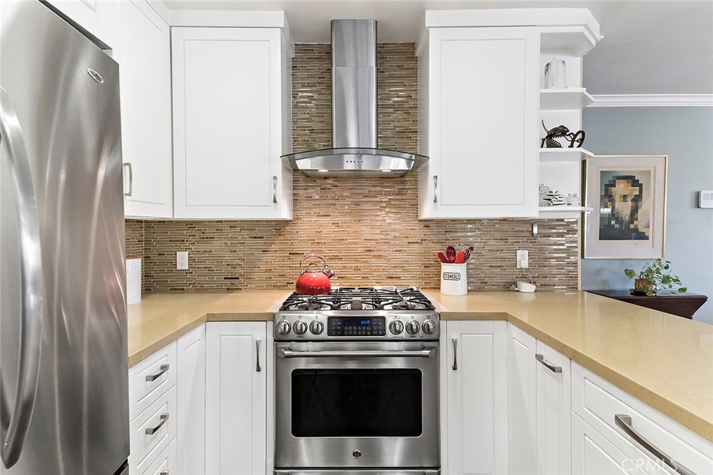 2818 Ostrom Avenue Long Beach, CA 90815 - Photo 11 of 41 a kitchen with stainless steel appliances a white stove top oven and sink