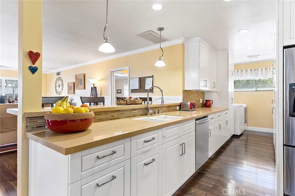 2818 Ostrom Avenue Long Beach, CA 90815 - Photo 12 of 41 a large white kitchen with a large window