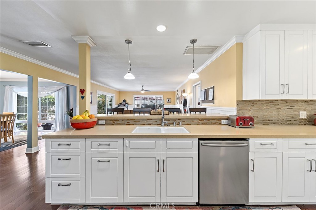 2818 Ostrom Avenue Long Beach, CA 90815 - Photo 13 of 41 a kitchen with white cabinets and sink