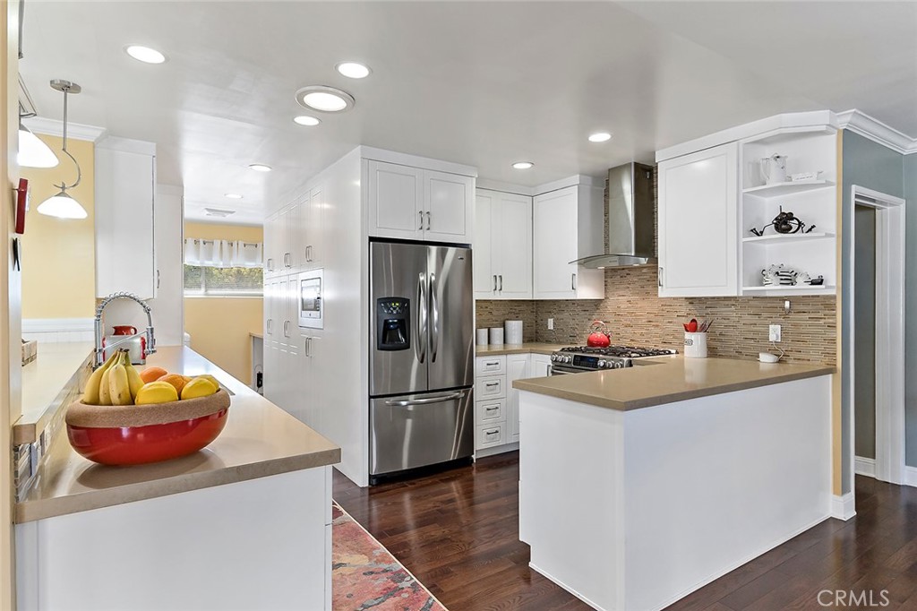 2818 Ostrom Avenue Long Beach, CA 90815 - Photo 15 of 41 a kitchen with a refrigerator a stove and a cabinets