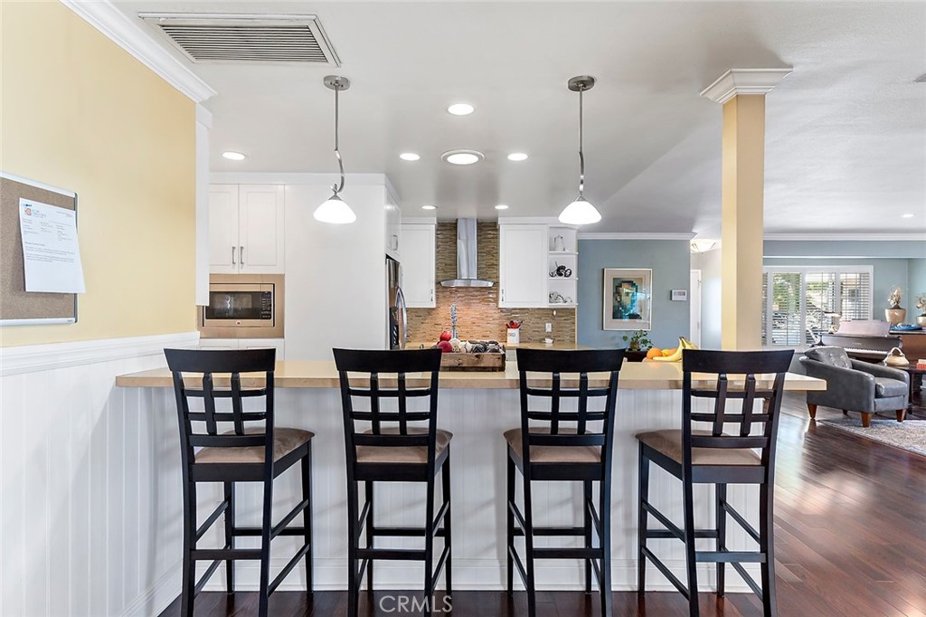 2818 Ostrom Avenue Long Beach, CA 90815 - Photo 16 of 41 a view of a dining room and livingroom with furniture wooden floor a chandelier