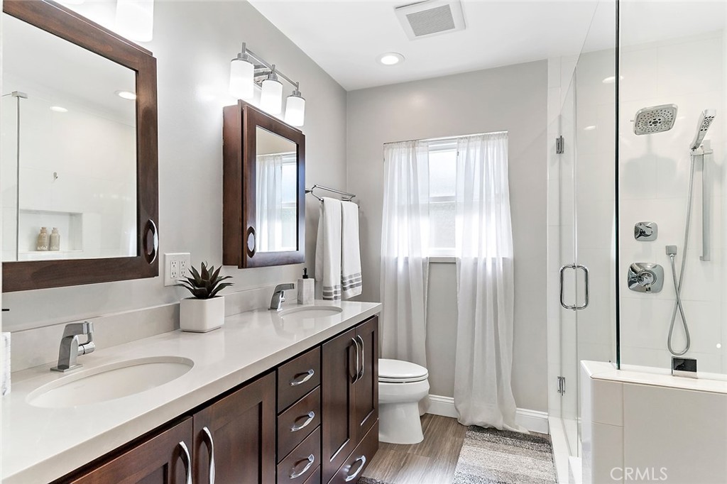 2818 Ostrom Avenue Long Beach, CA 90815 - Photo 29 of 41 a bathroom with a double vanity sink toilet and shower