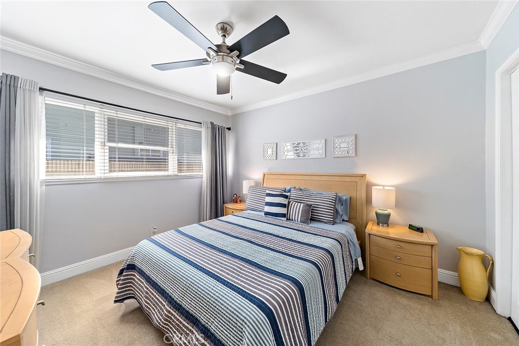 2818 Ostrom Avenue Long Beach, CA 90815 - Photo 31 of 41 a bedroom with a bed and a chandelier