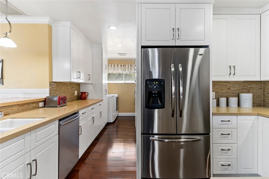 2818 Ostrom Avenue Long Beach, CA 90815 - Photo 9 of 41 a kitchen with a refrigerator a sink and dishwasher