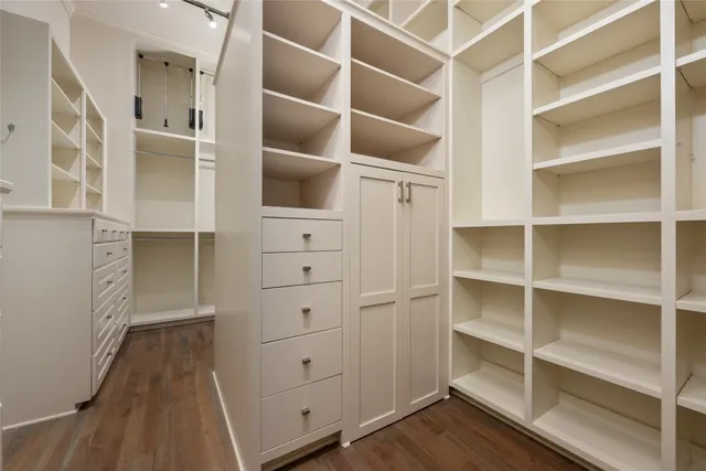 a view of walk in closet with empty racks