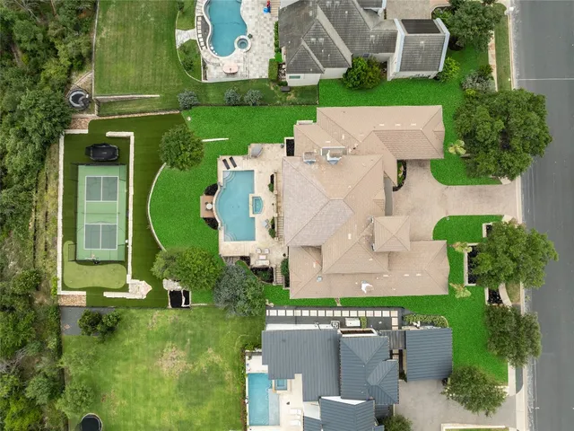 an aerial view of a house with a garden and trees