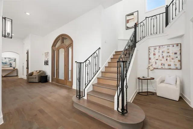 a view of entryway and hall with wooden floor