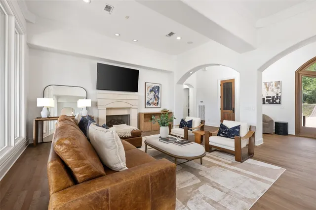 a living room with fireplace furniture and a flat screen tv