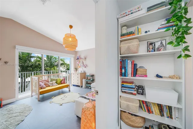 a bedroom with furniture and a large window