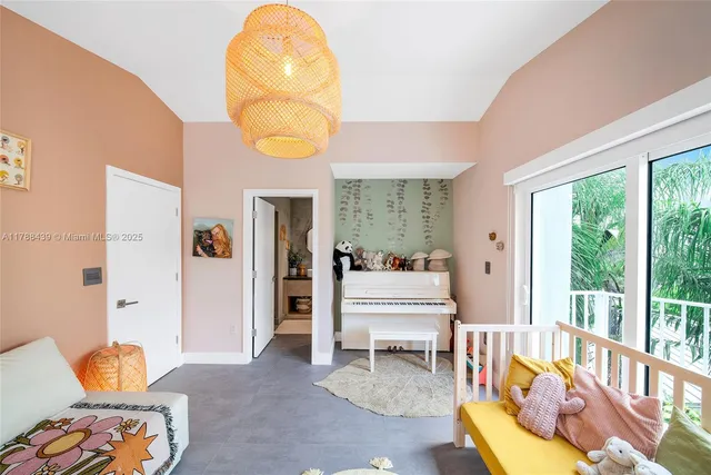 a living room with furniture and a floor to ceiling window