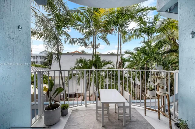 a balcony with furniture and a potted plant