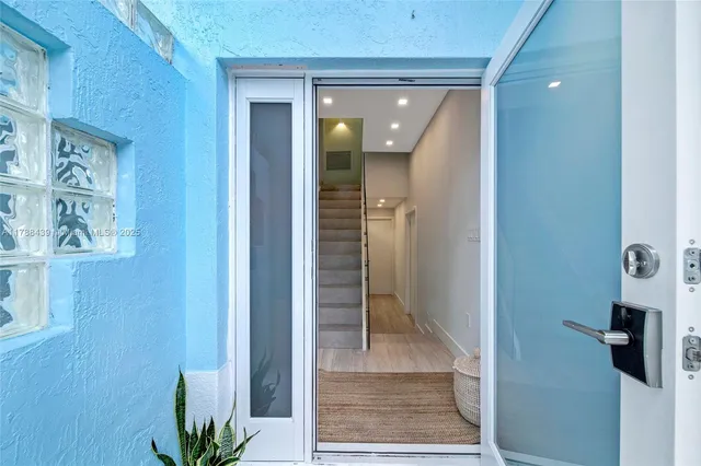 a kitchen with kitchen island a sink stainless steel appliances and cabinets