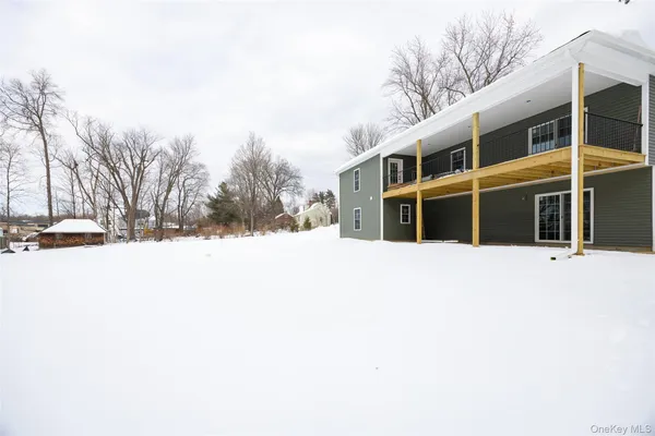 a view of building with snow on the road