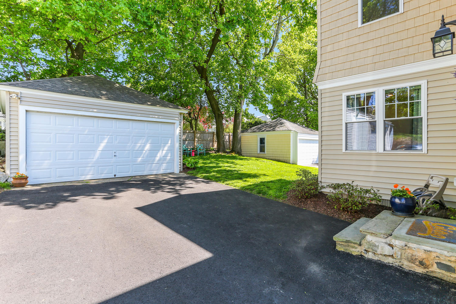 183 Rockland Road Fairfield, CT 06825 - Photo 22 of 27 a front view of a house with a yard and garage