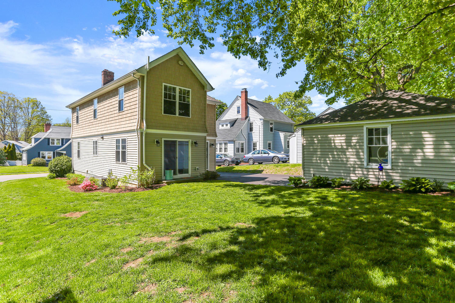183 Rockland Road Fairfield, CT 06825 - Photo 23 of 27 a front view of a house with a yard