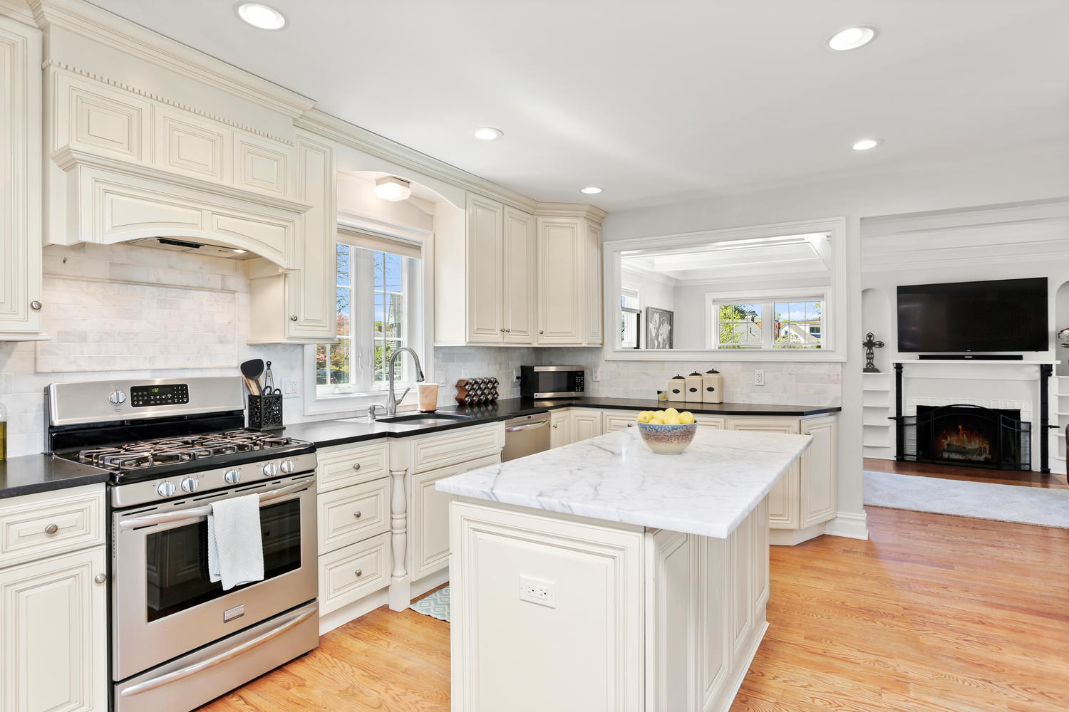 183 Rockland Road Fairfield, CT 06825 - Photo 4 of 27 a kitchen with stainless steel appliances white cabinets and a stove top oven