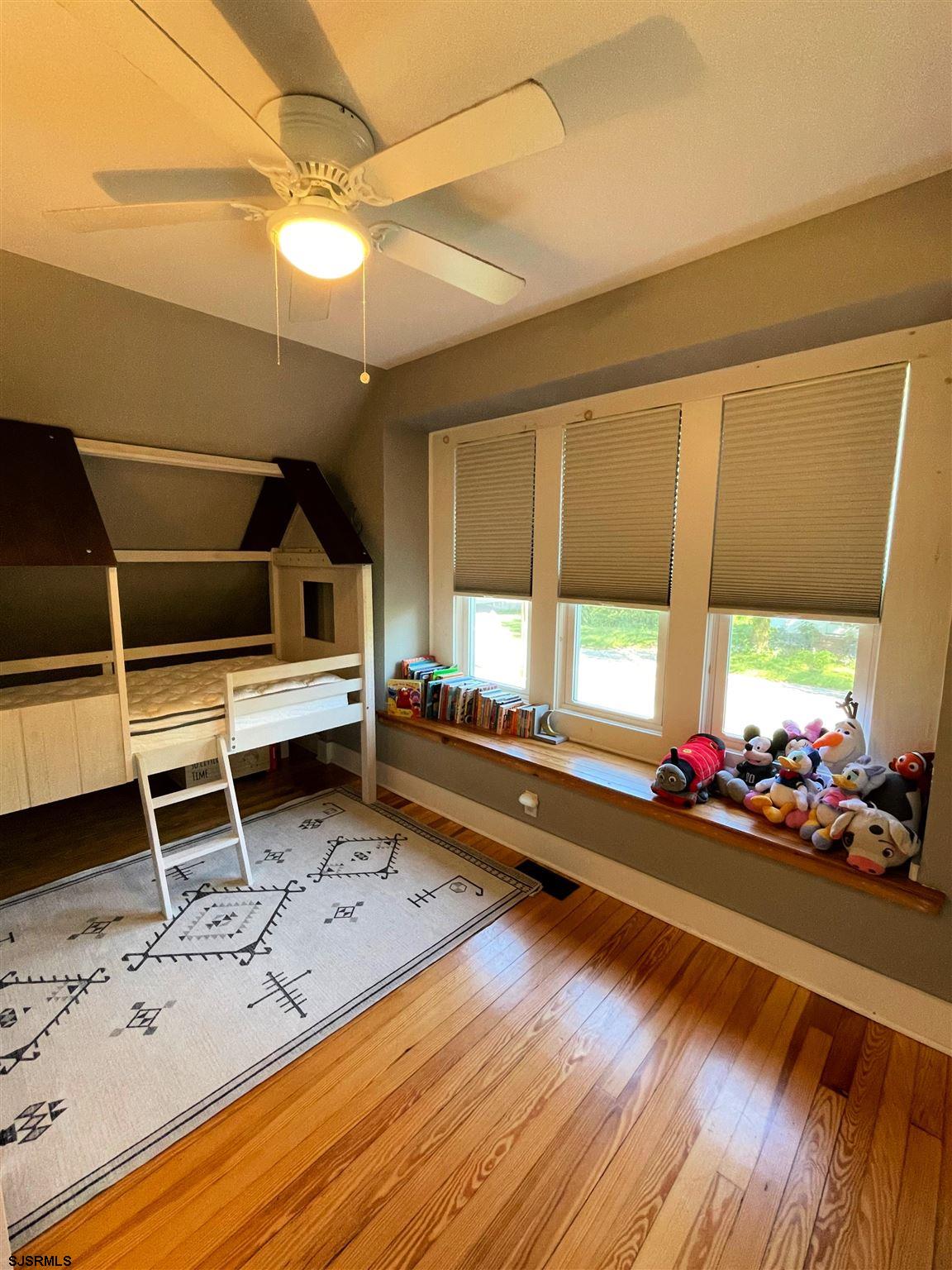 220 West Mill Road Northfield, NJ 08225 - Photo 12 of 22 a room with gym equipment wooden floor and window