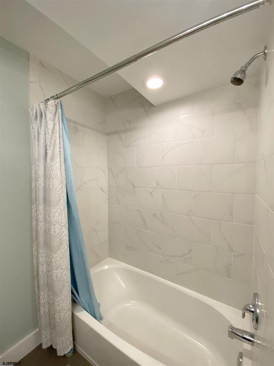 220 West Mill Road Northfield, NJ 08225 - Photo 15 of 22 a bathroom with a shower and a bath tub