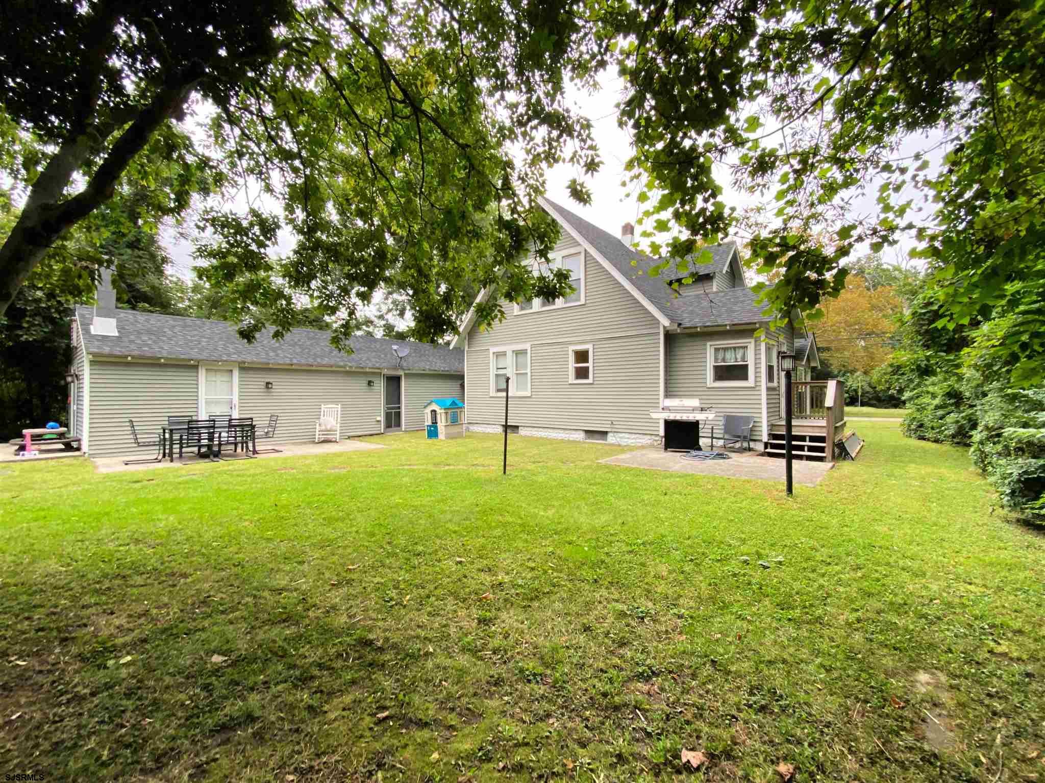 220 West Mill Road Northfield, NJ 08225 - Photo 20 of 22 a front view of house with yard and seating area