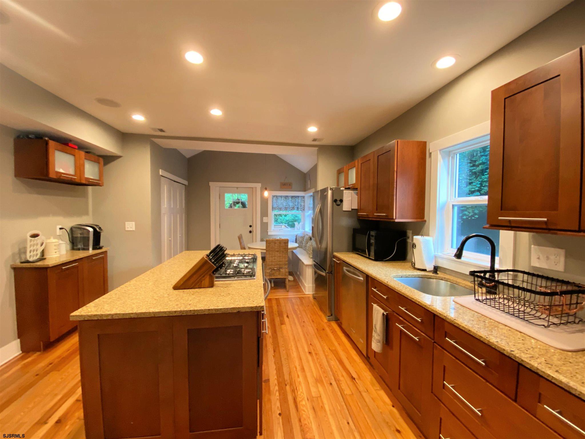 220 West Mill Road Northfield, NJ 08225 - Photo 5 of 22 a kitchen with kitchen island a sink appliances and cabinets
