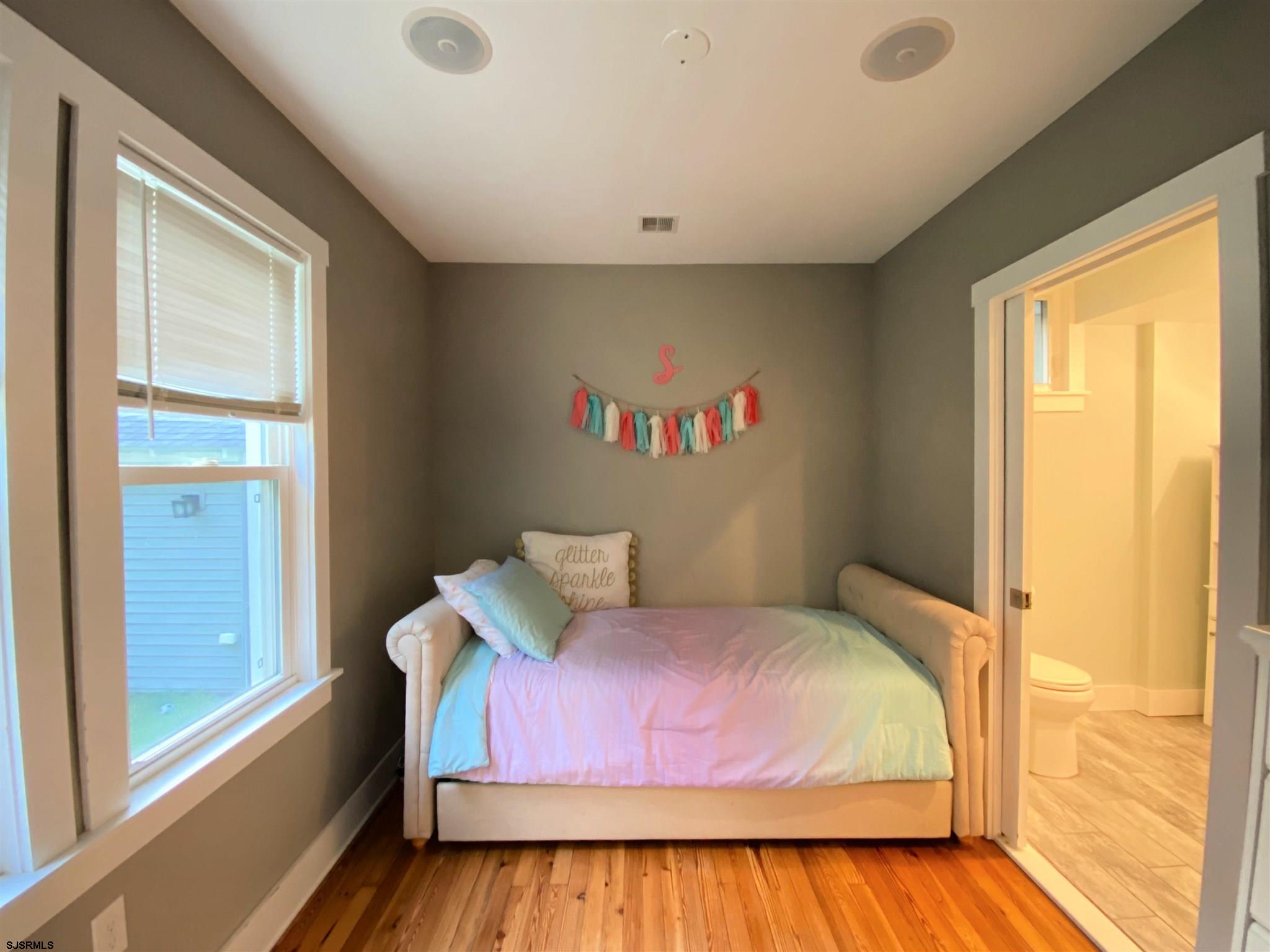 220 West Mill Road Northfield, NJ 08225 - Photo 8 of 22 a bedroom with a bed and wooden floor